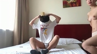 A Pair Of Lovers From China Share A Private Moment In A Hotel Room